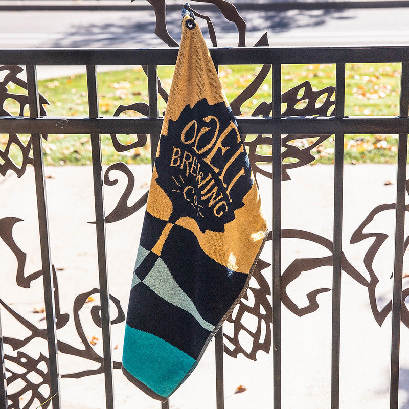 Sports towel with Odell logo hanging on a fence