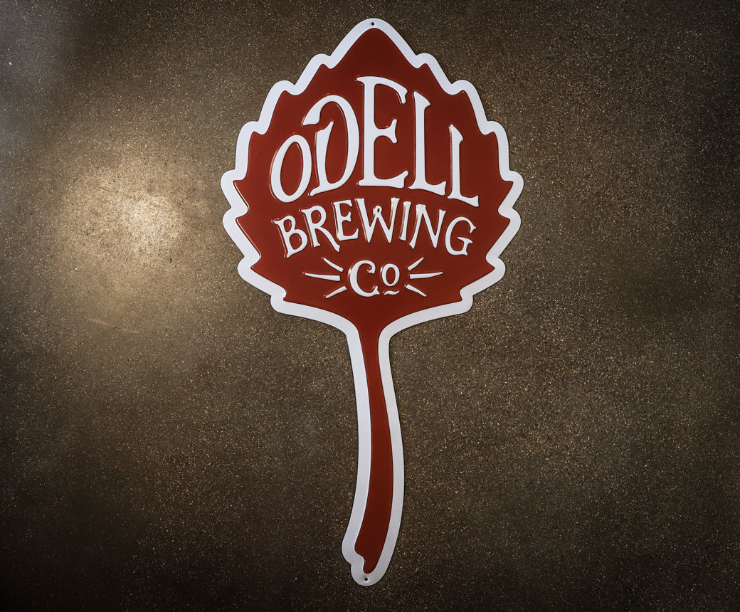 Metal tacker in the shape of the Odell Brewing leaf logo