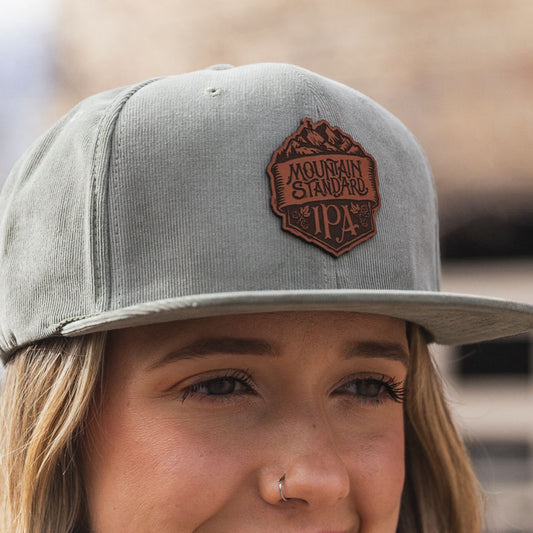 Odell mountain standard leather patch on light olive, corduroy flat bill hat