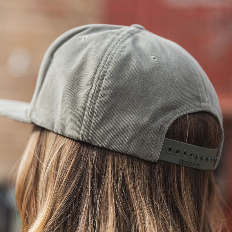 Odell mountain standard leather patch on light olive, corduroy flat bill hat