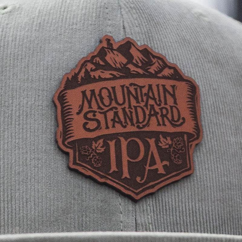 Odell mountain standard leather patch on light olive, corduroy flat bill hat