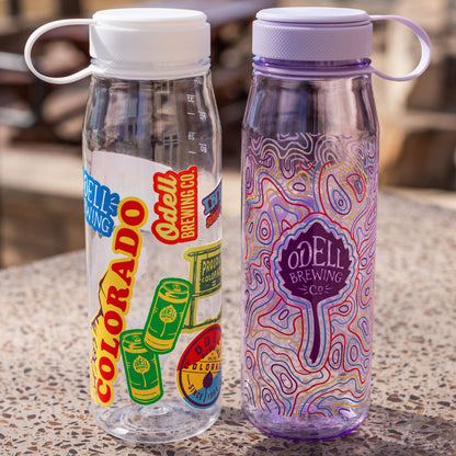 Two Miir water bottles, one with stickers and one with a wavy design 