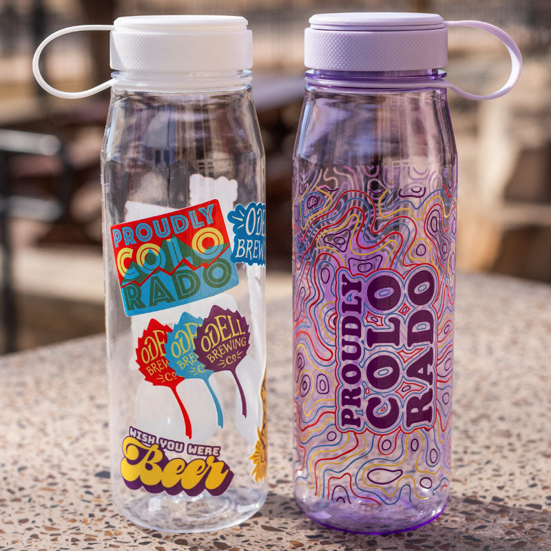 Two Miir water bottles, one with stickers and one with a wavy design 