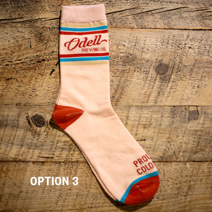 Odell socks in a beige color with blue and red stripes