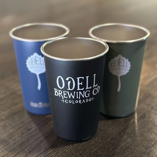 Three stainless steel mugs with Odell Brewing written on one side and the Odell Brewing leaf on the other side